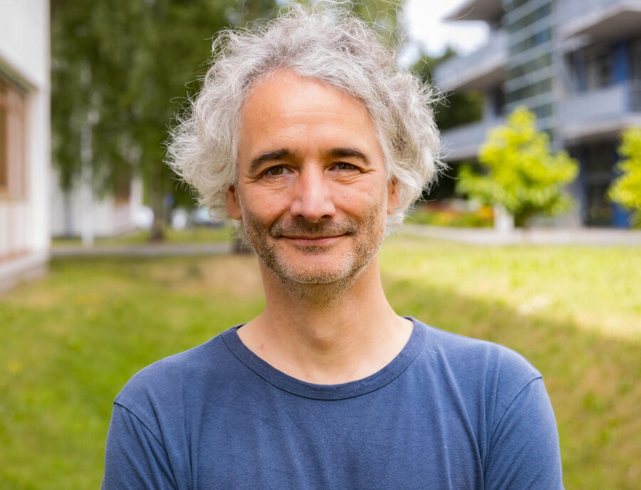 a middle-aged man smiling at the camera