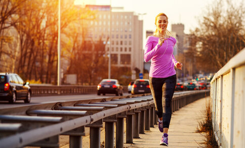 Woman jogging along a road.
